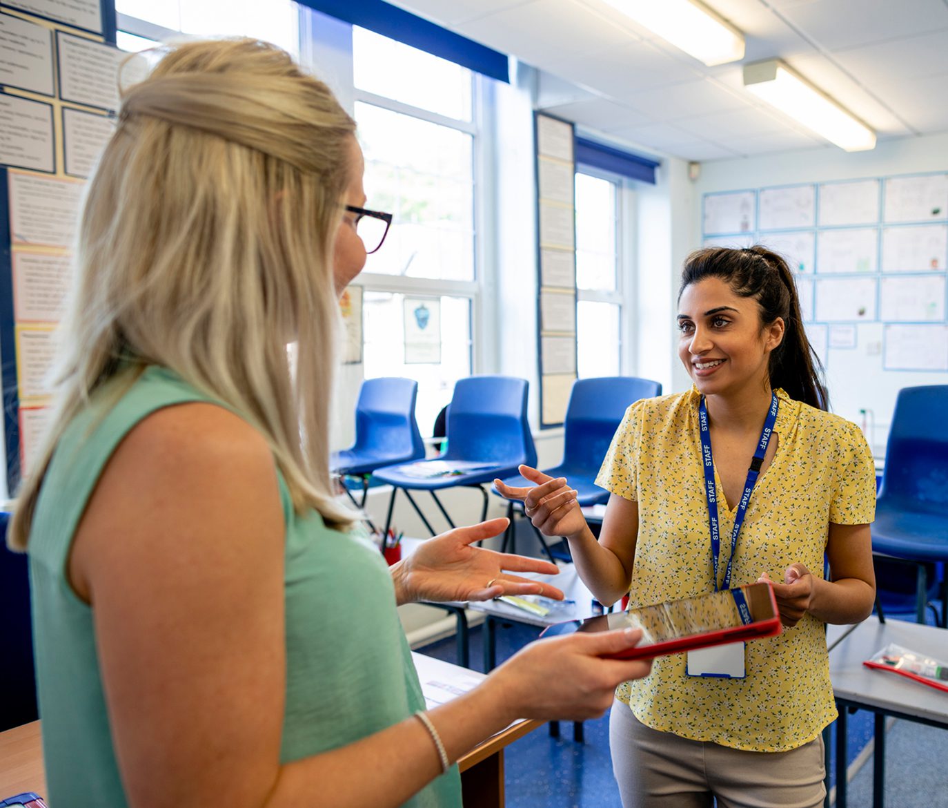 Two women conversing in educational setting