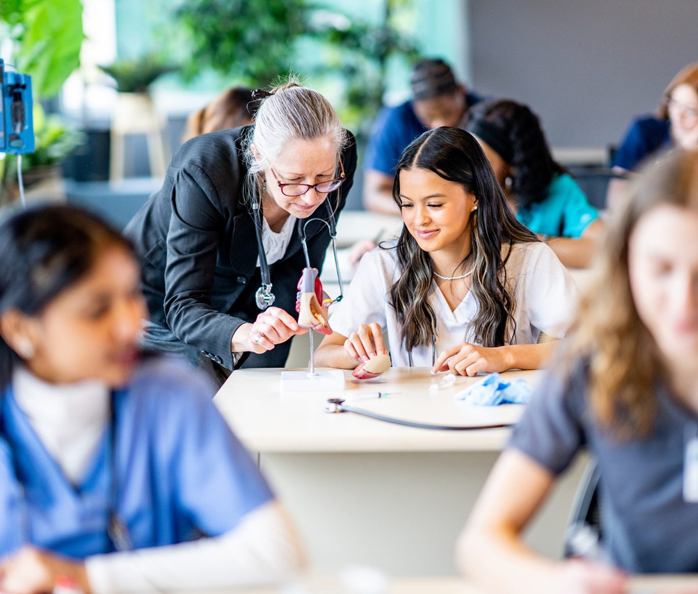 Teacher assisting student in classroom